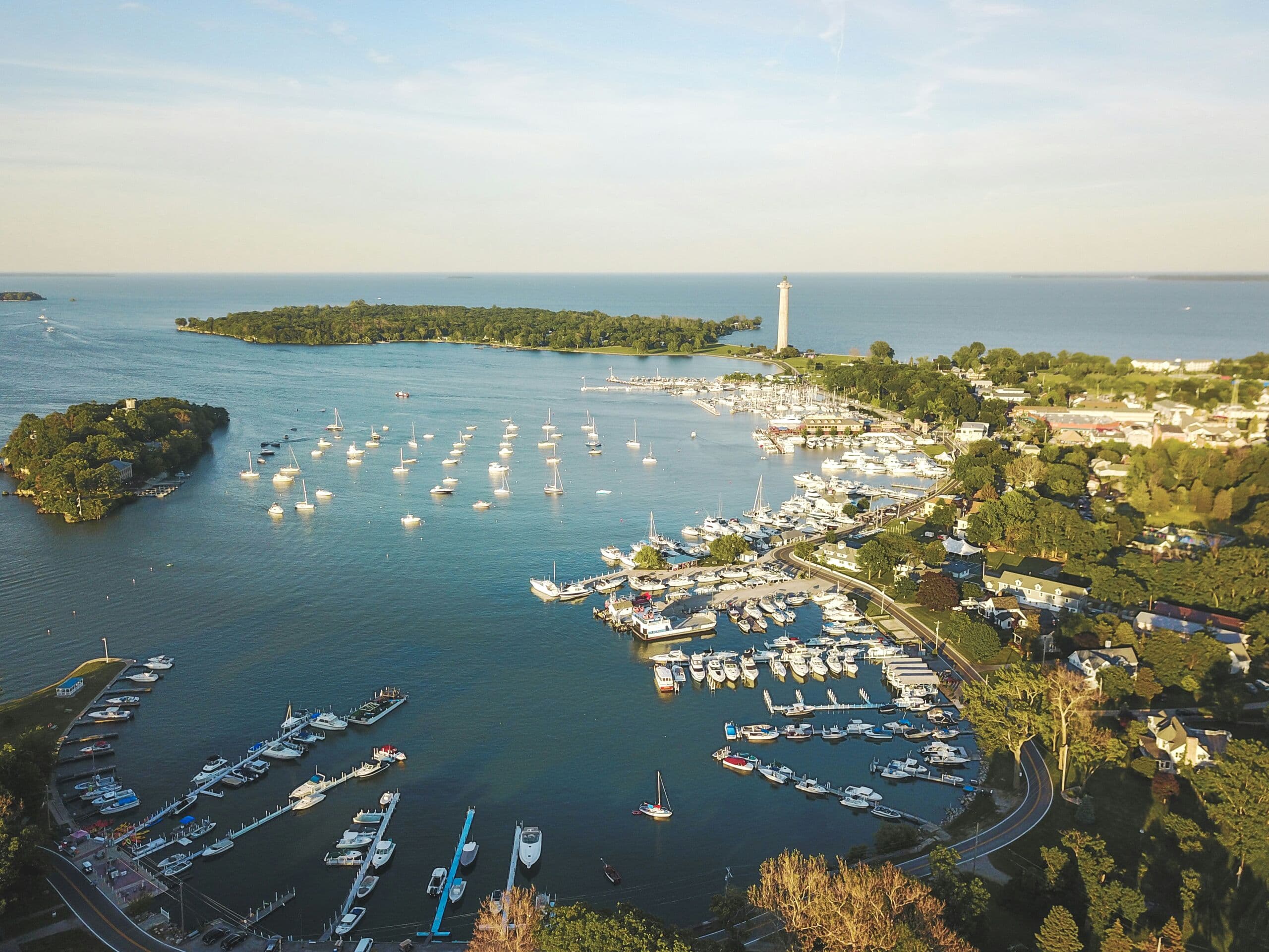 Put-in-Bay from above at golden hour: a harbor full of boats, the islands and Perry’s Monument